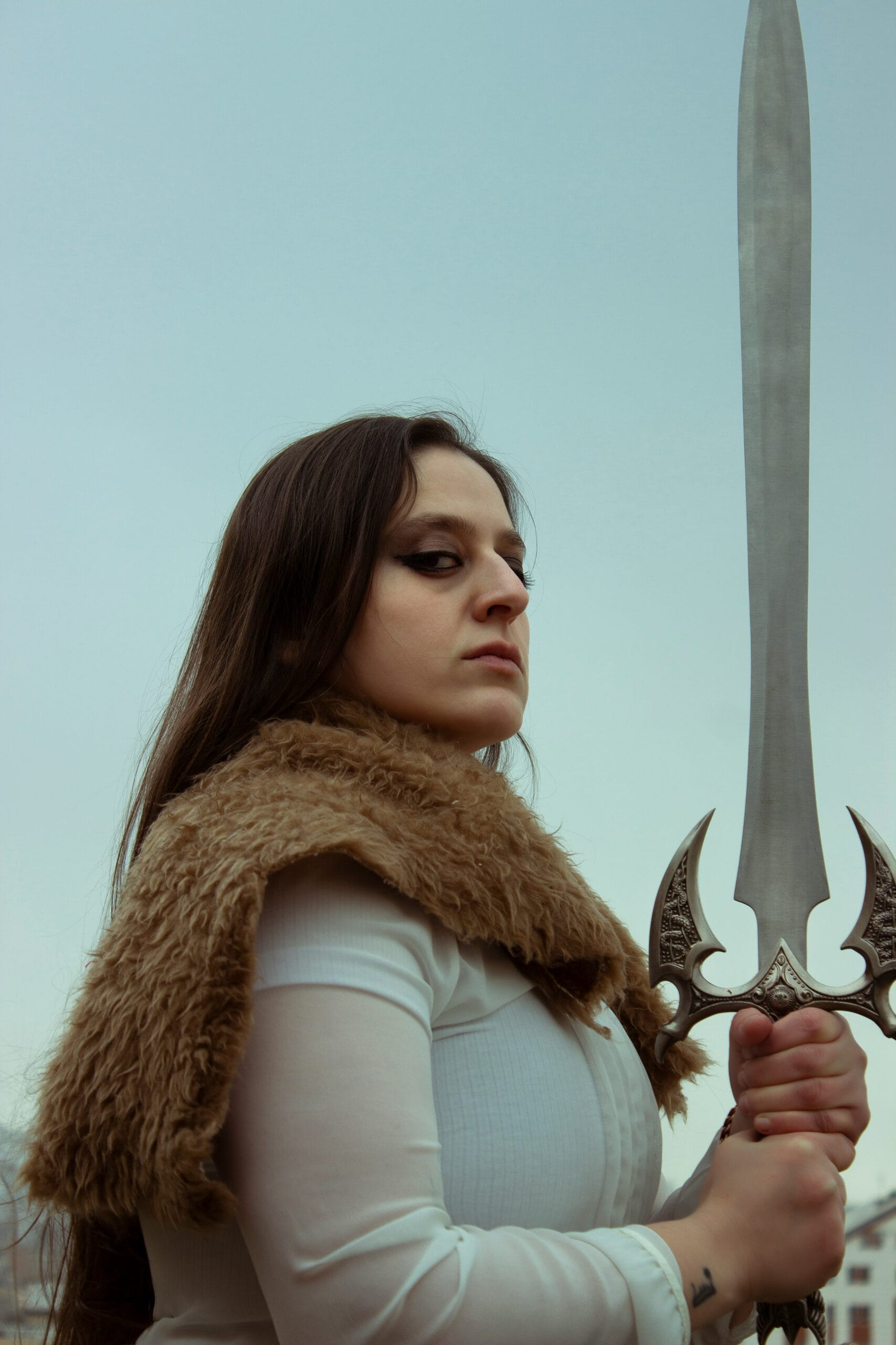 Legends of the Frozen North: Viking Tales and Mythology 2 a woman in a fur vest holding a large sword