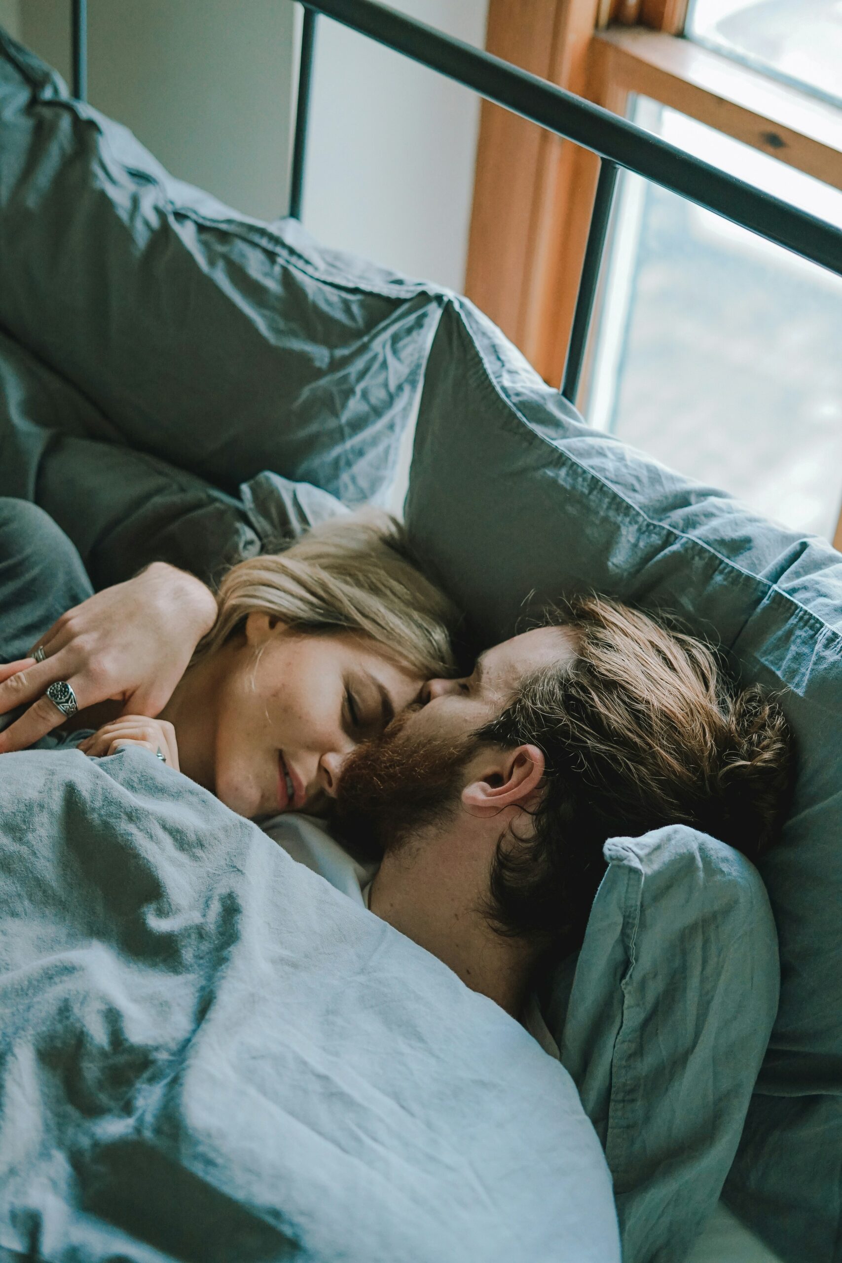 The Light We Lost: A Journey Through Love and Choices 7 man kissing woman's forehead while lying on bed